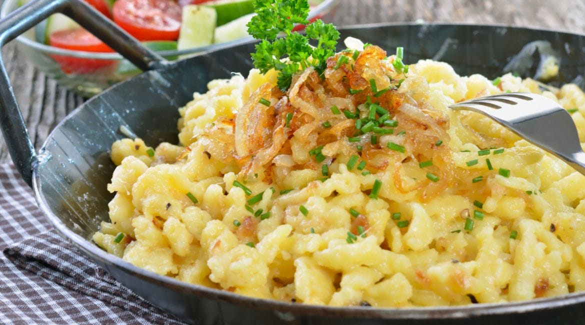 raditional German Käsespätzle with melted cheese and crispy onions