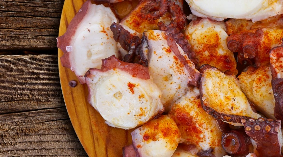 Traditional Spanish Pulpo a la Gallega with octopus, olive oil, paprika, and coarse salt