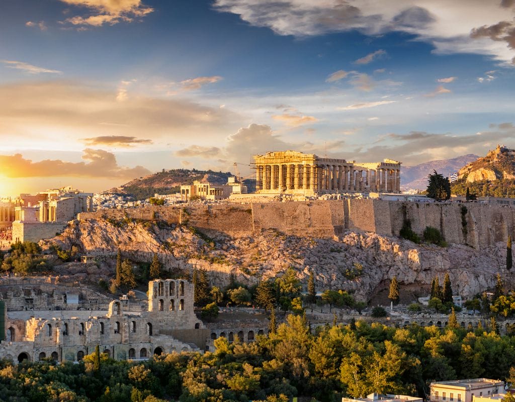 The Acropolis of Athens, Greece, featuring the Parthenon with its classical Doric columns at sunset.