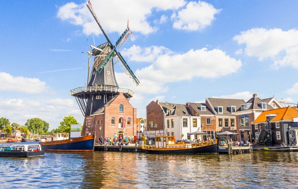 Iconic Dutch windmill by the water, symbolizing the Netherlands' rich cultural heritage and scenic beauty