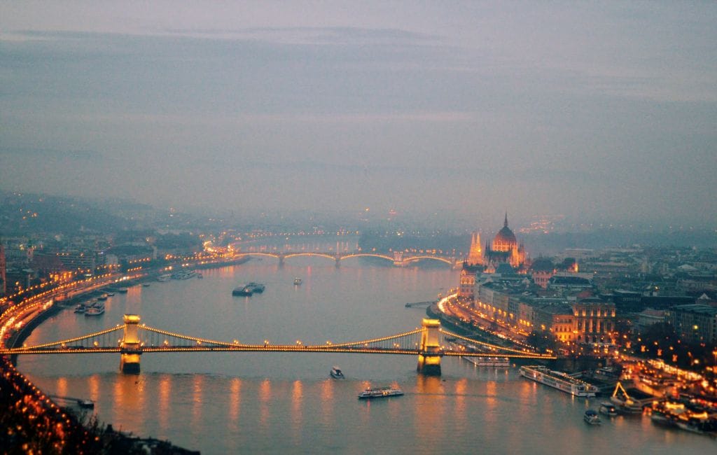Budapest at evening, showcasing the iconic bridge and cityscape along the Danube River, reflecting Hungary's cultural beauty