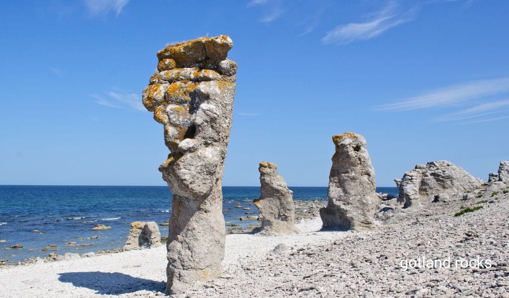 Stunning rock formations on the coast of Gotland, Sweden, with clear blue skies and the Baltic Sea in the background