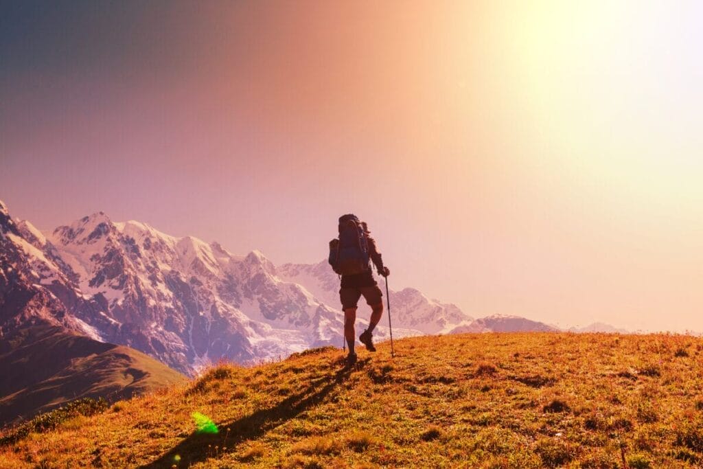 Hiker enjoying sunset on an Alpine summit