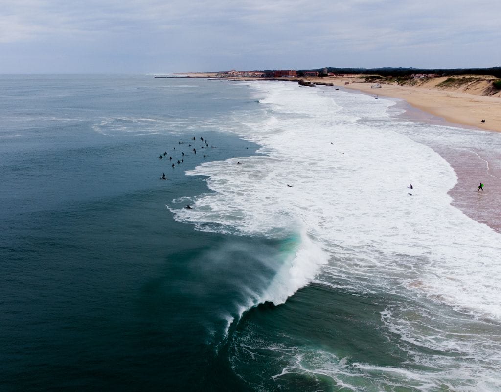 A surfer catching a powerful wave at La Gravière, Hossegor, highlighting the thrill of surfing in Europe's surf capital