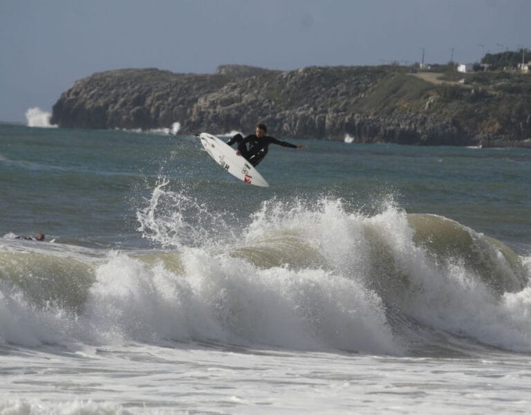 Surfer riding a perfect barrel at Supertubos, Peniche, Portugal's surf capital.