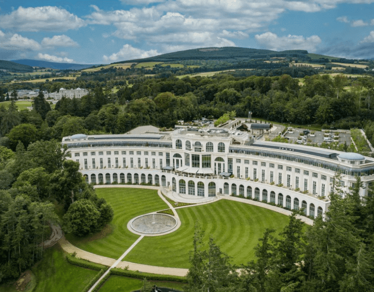 Exterior view of the elegant Powerscourt Hotel in Wicklow, showcasing its luxurious architecture and picturesque surroundings.