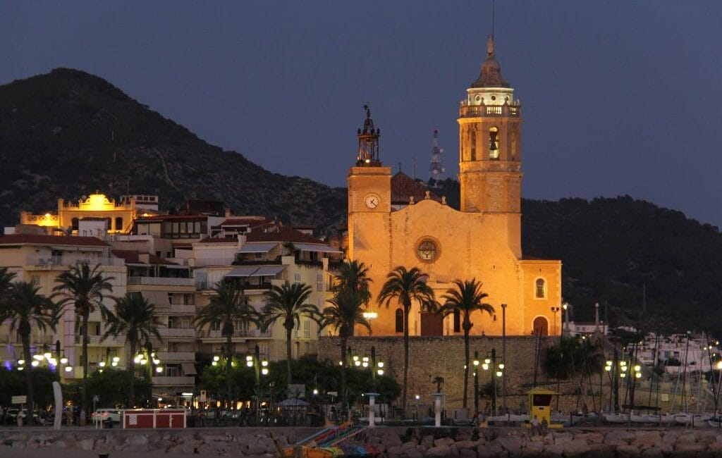 LGBTQ visitors enjoying the vibrant atmosphere and beautiful beaches of Sitges, a premier European LGBTQ destination.