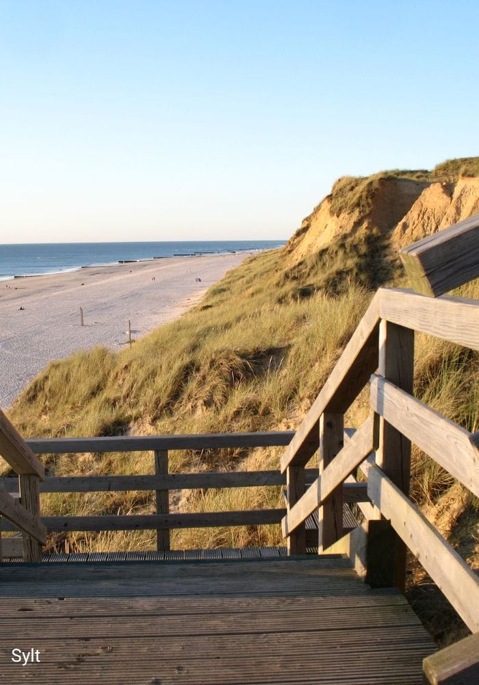 Wooden staircase leading from the high dunes to the beach on Sylt
