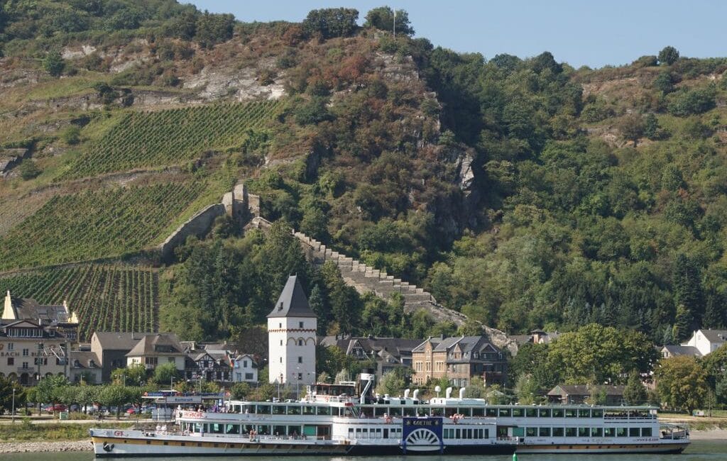 View of the Rhein River with picturesque landscapes and historic cities along the riverbanks.