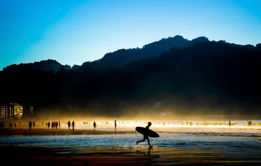 Surfers catching waves at sunset in Vieux Boucau, France's picturesque surf paradise