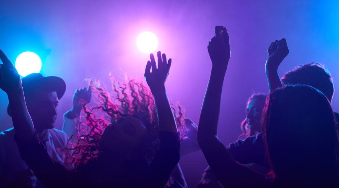 People dancing at a vibrant nightclub in Amsterdam.